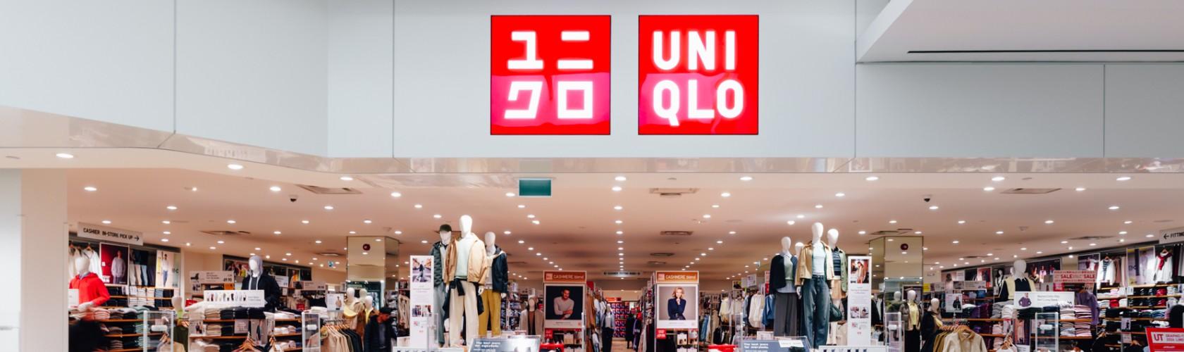 UNIQLO store interior with organized clothing displays and mannequins showcasing everyday wear